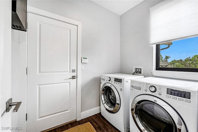 laundry room featuring washing machine and dryer and dark hardwood / wood-style flooring