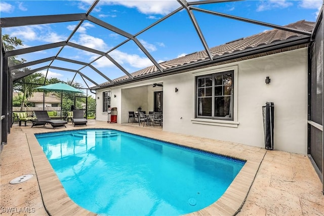 1140 Jeronimo Dr, Naples, FL 34103 - swimming pool featuring a patio, ceiling fan, outdoor dining space, and glass enclosure