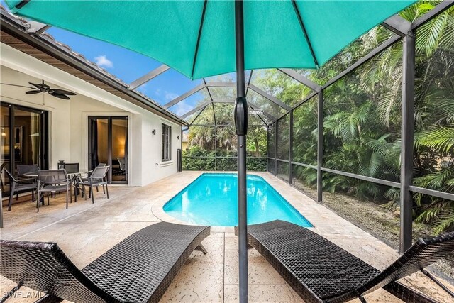 view of pool featuring ceiling fan and a patio