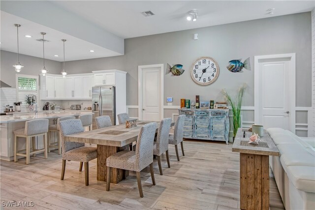 dining area featuring light wood-type flooring