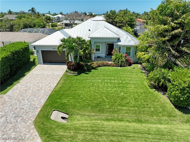 view of front of property featuring a front yard and a garage