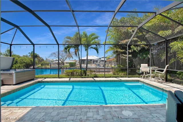 view of pool featuring a lanai, a water view, and a patio