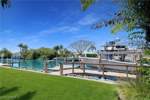 dock area with a lawn and a water view