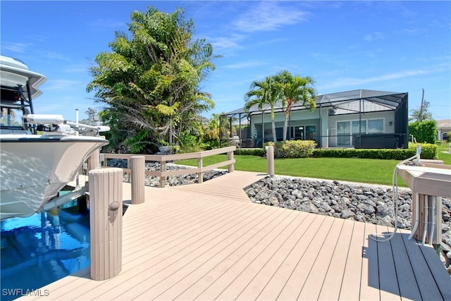 wooden terrace with a lanai and a lawn