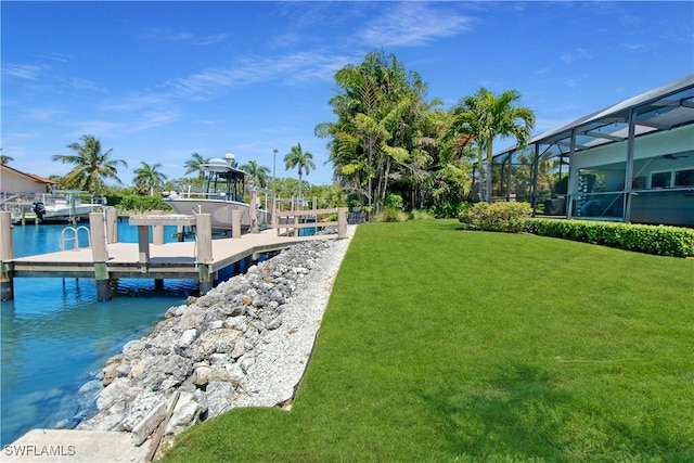 dock area with a yard, a water view, and a lanai