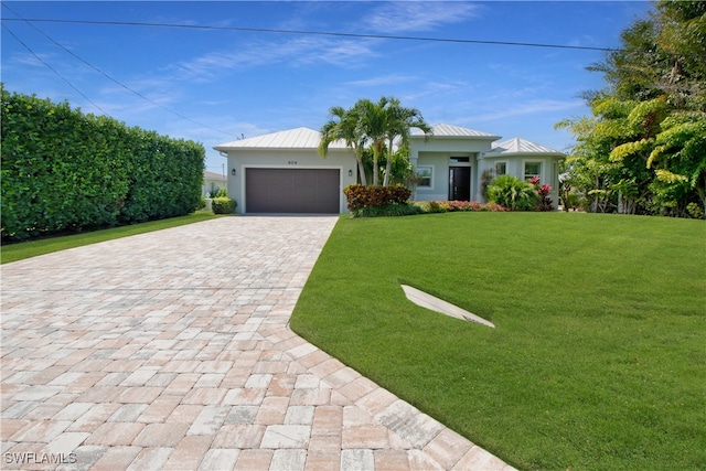 view of front facade with a garage and a front lawn