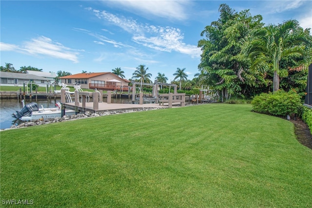 view of yard featuring a water view and a dock