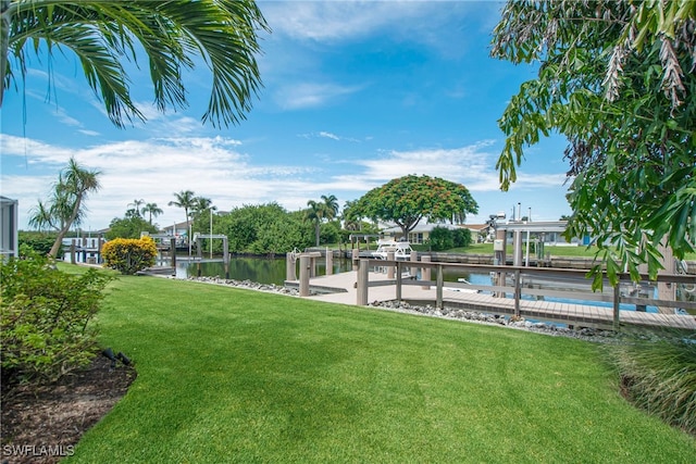 view of yard with a dock and a water view