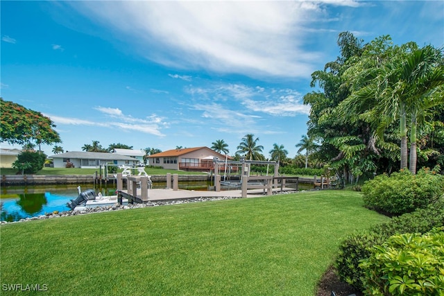 dock area featuring a water view and a yard