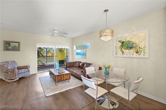 living room with ceiling fan and dark hardwood / wood-style flooring