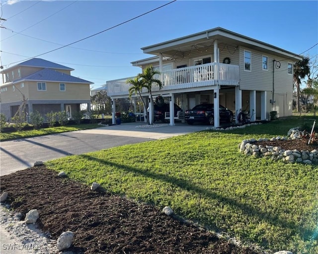 exterior space featuring a carport, a balcony, and a front lawn