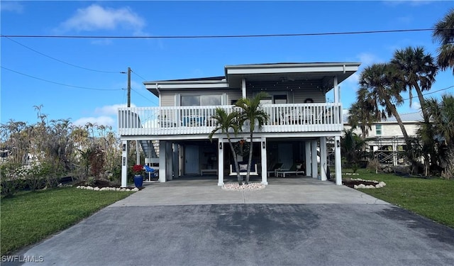 beach home featuring a carport and a front yard