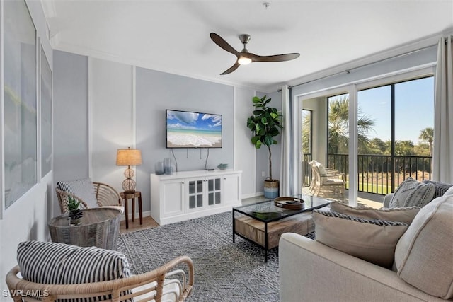 living room featuring crown molding and ceiling fan