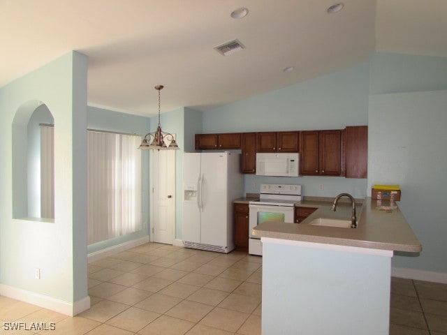 kitchen featuring white appliances, hanging light fixtures, vaulted ceiling, kitchen peninsula, and a chandelier