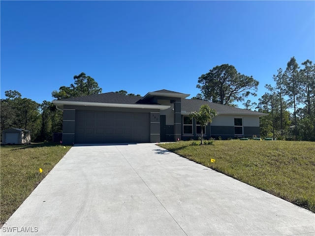 view of front of home with a garage and a front lawn