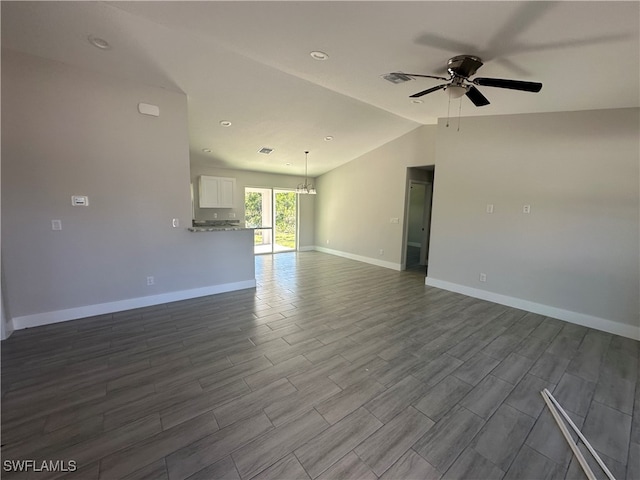 interior space with ceiling fan, wood-type flooring, and vaulted ceiling