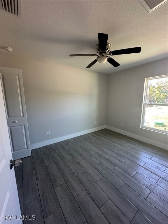 unfurnished room featuring ceiling fan, hardwood / wood-style floors, and a textured ceiling