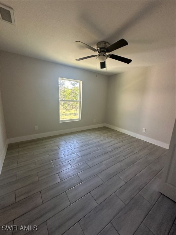 empty room with ceiling fan and wood-type flooring