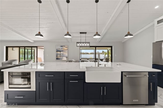 kitchen featuring a wealth of natural light, sink, pendant lighting, and appliances with stainless steel finishes