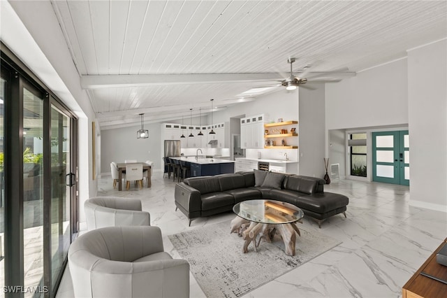 living room featuring french doors, ceiling fan, sink, lofted ceiling with beams, and wooden ceiling