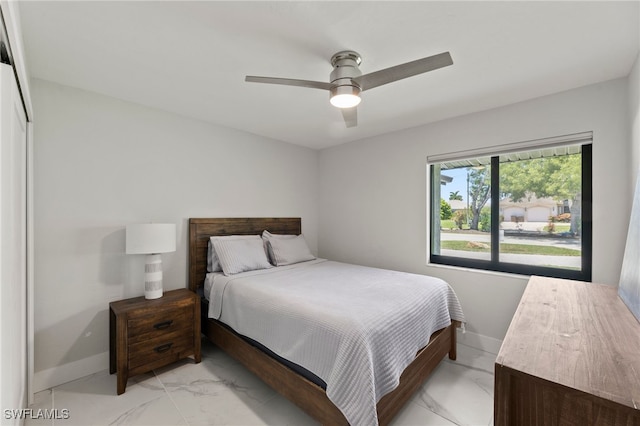 bedroom with ceiling fan and a closet