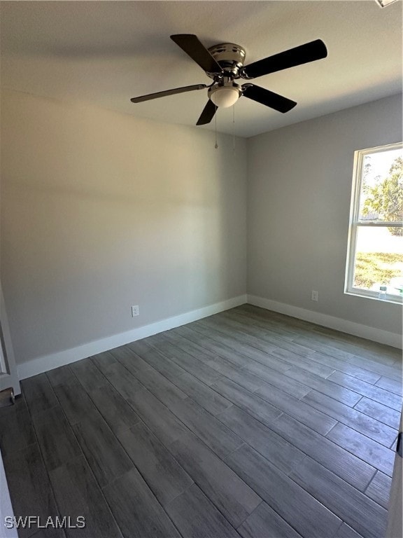 empty room with ceiling fan and wood-type flooring