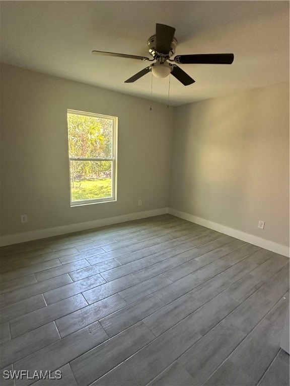 spare room with ceiling fan and hardwood / wood-style flooring