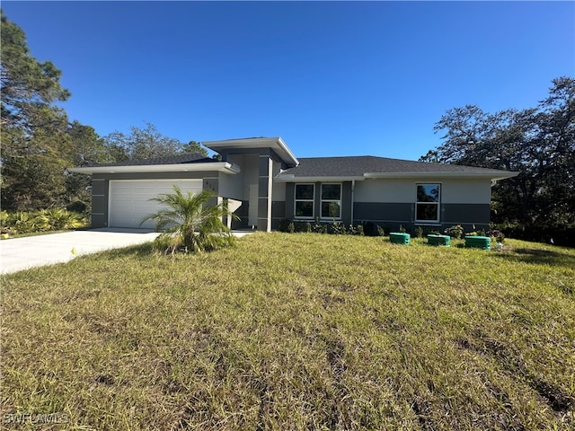 view of front of house with a garage and a front yard