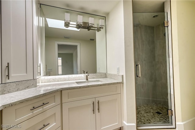 bathroom featuring vanity and a shower with shower door