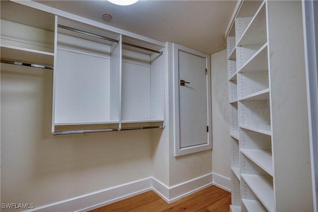 spacious closet featuring hardwood / wood-style flooring