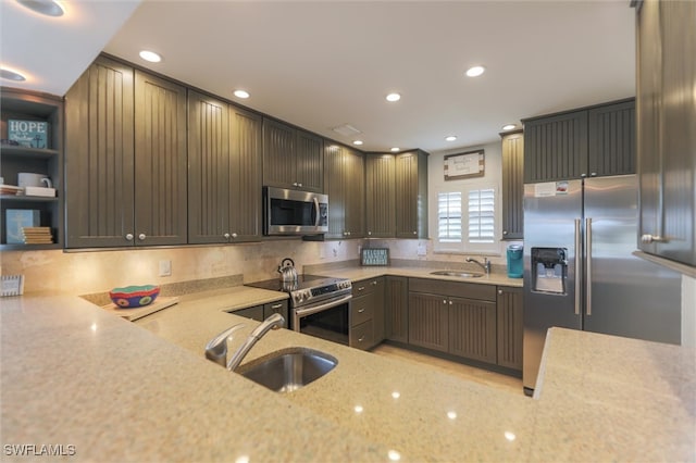 kitchen with decorative backsplash, dark brown cabinetry, sink, and appliances with stainless steel finishes