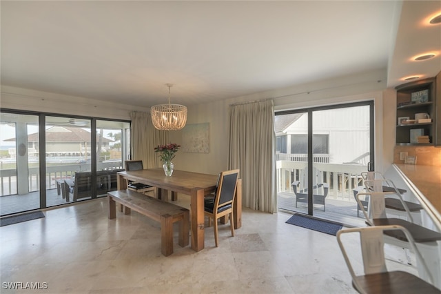 dining room with a notable chandelier and plenty of natural light