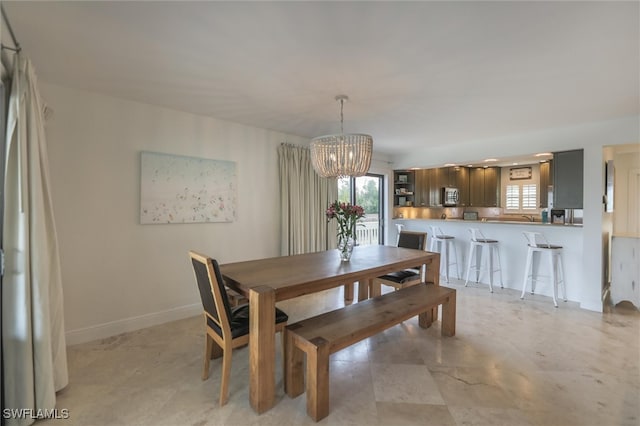 dining space featuring a healthy amount of sunlight and a notable chandelier