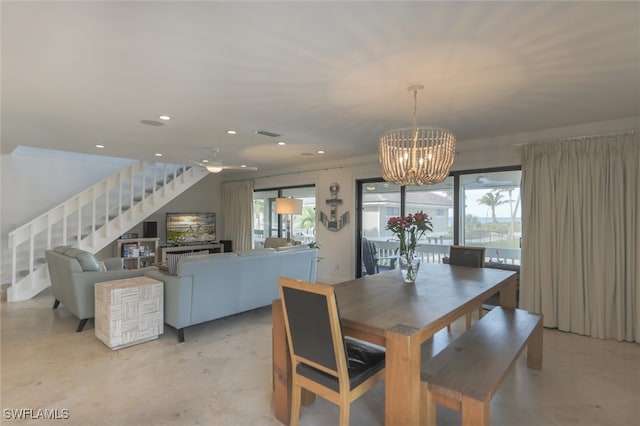 dining space featuring ceiling fan with notable chandelier and a healthy amount of sunlight