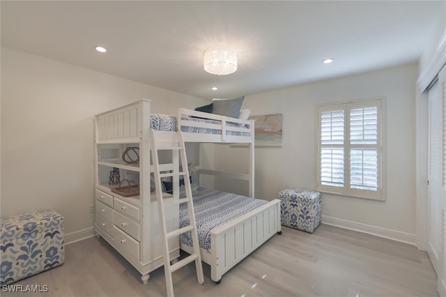 bedroom with light wood-type flooring and a closet