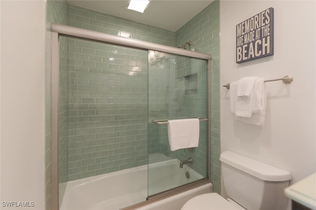 bathroom with toilet and enclosed tub / shower combo