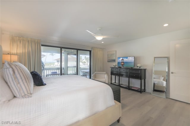 bedroom with ceiling fan, wood-type flooring, and access to outside