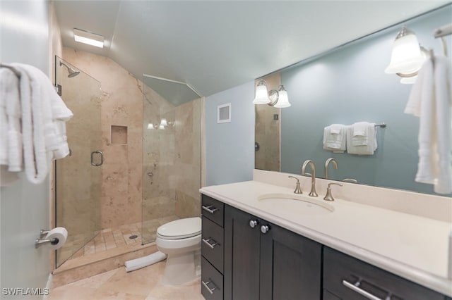 bathroom featuring vanity, a shower with door, vaulted ceiling, tile patterned flooring, and toilet