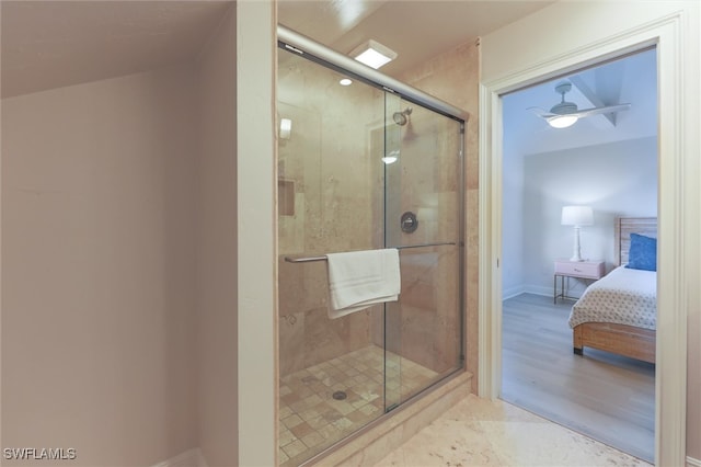 bathroom with an enclosed shower, hardwood / wood-style flooring, and ceiling fan