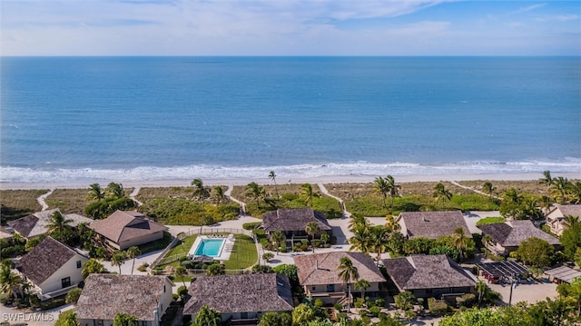 birds eye view of property with a water view and a view of the beach