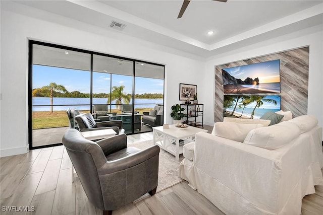 living room with ceiling fan and light hardwood / wood-style floors