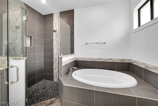 bathroom with separate shower and tub