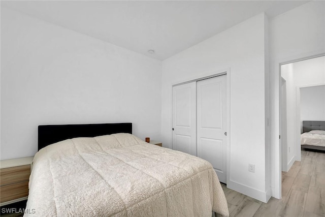 bedroom featuring a closet and light hardwood / wood-style flooring