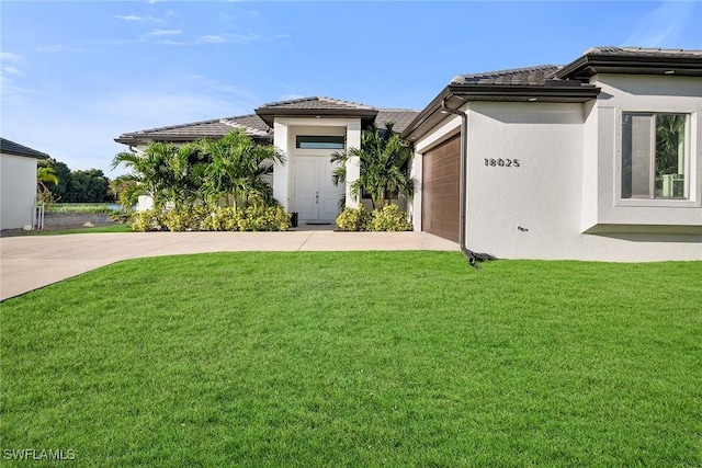 view of front of home with a garage and a front yard