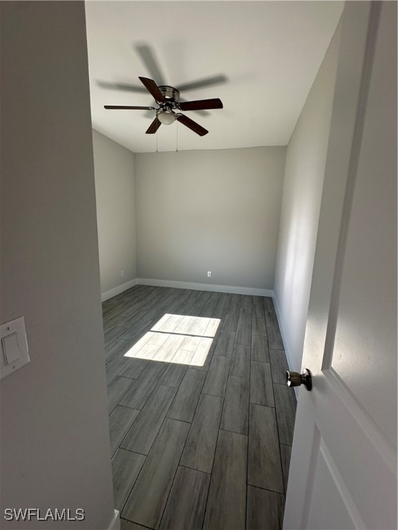 empty room featuring ceiling fan and dark wood-type flooring