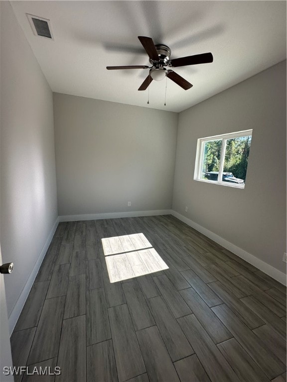 unfurnished room with dark hardwood / wood-style flooring and ceiling fan