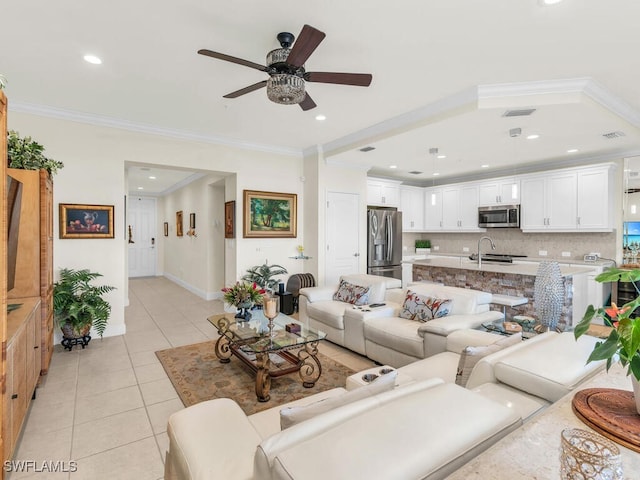 tiled living room featuring ceiling fan and crown molding