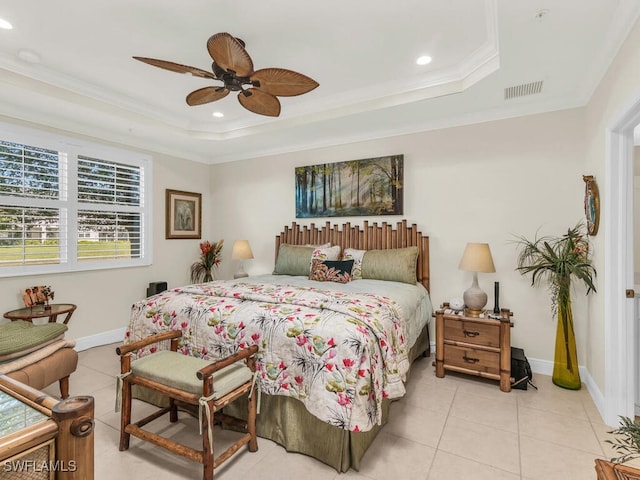 tiled bedroom featuring ceiling fan, crown molding, and a tray ceiling