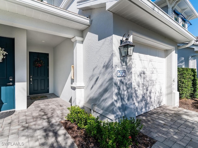 doorway to property with a garage