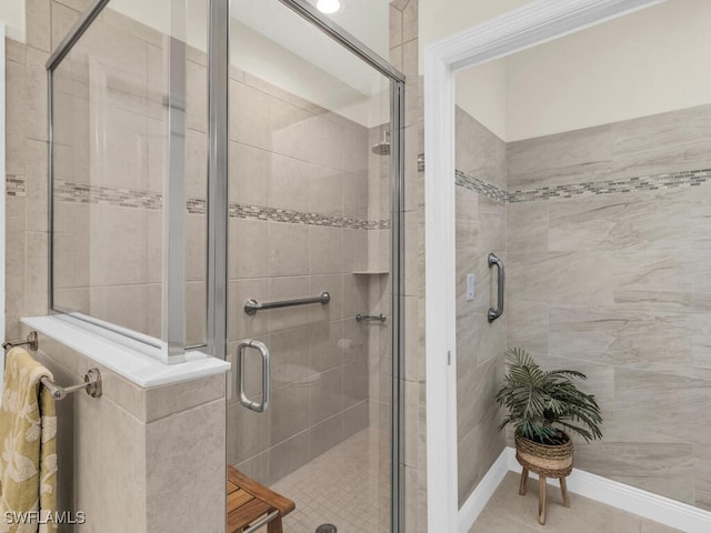 bathroom with tile patterned flooring and a shower with shower door